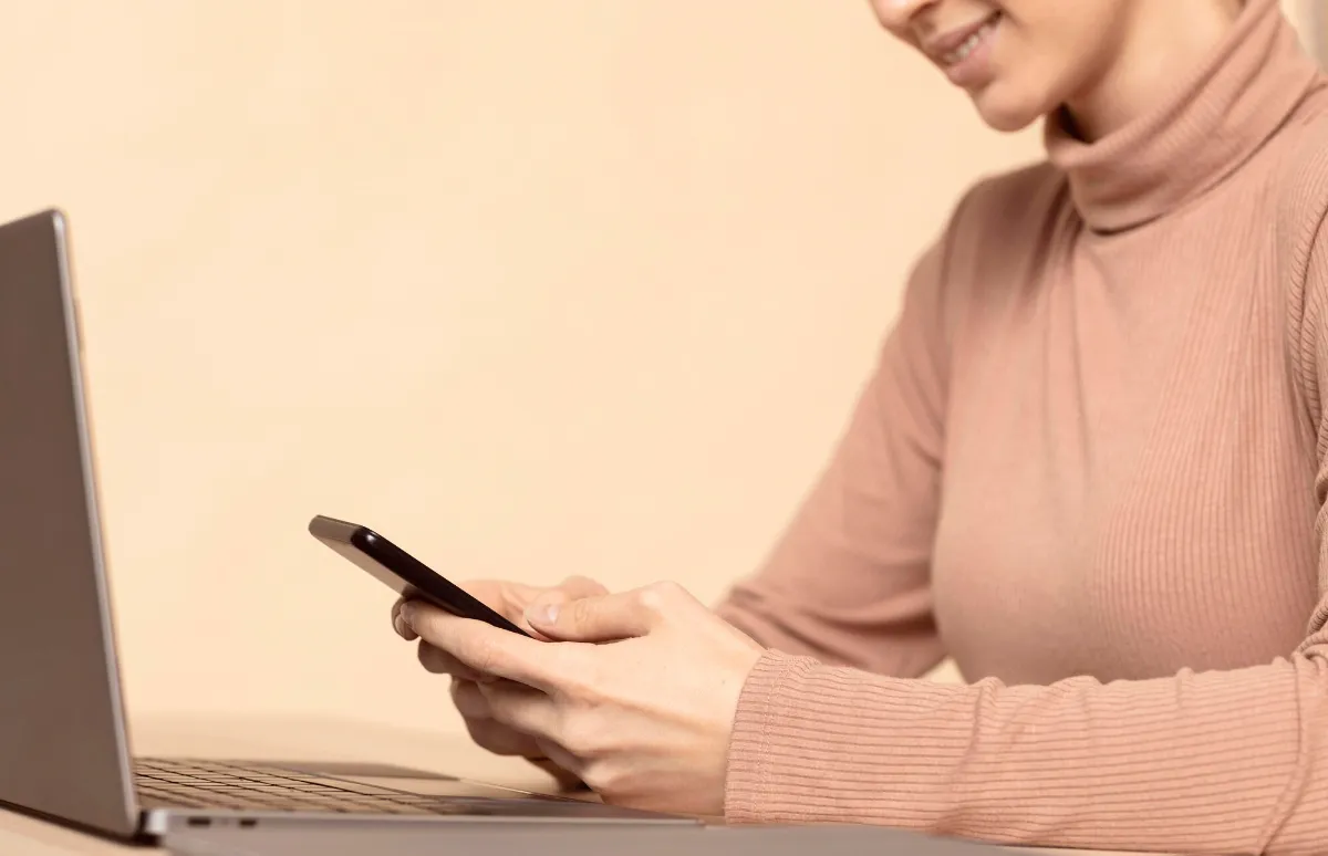 Sideways woman using her smartphone